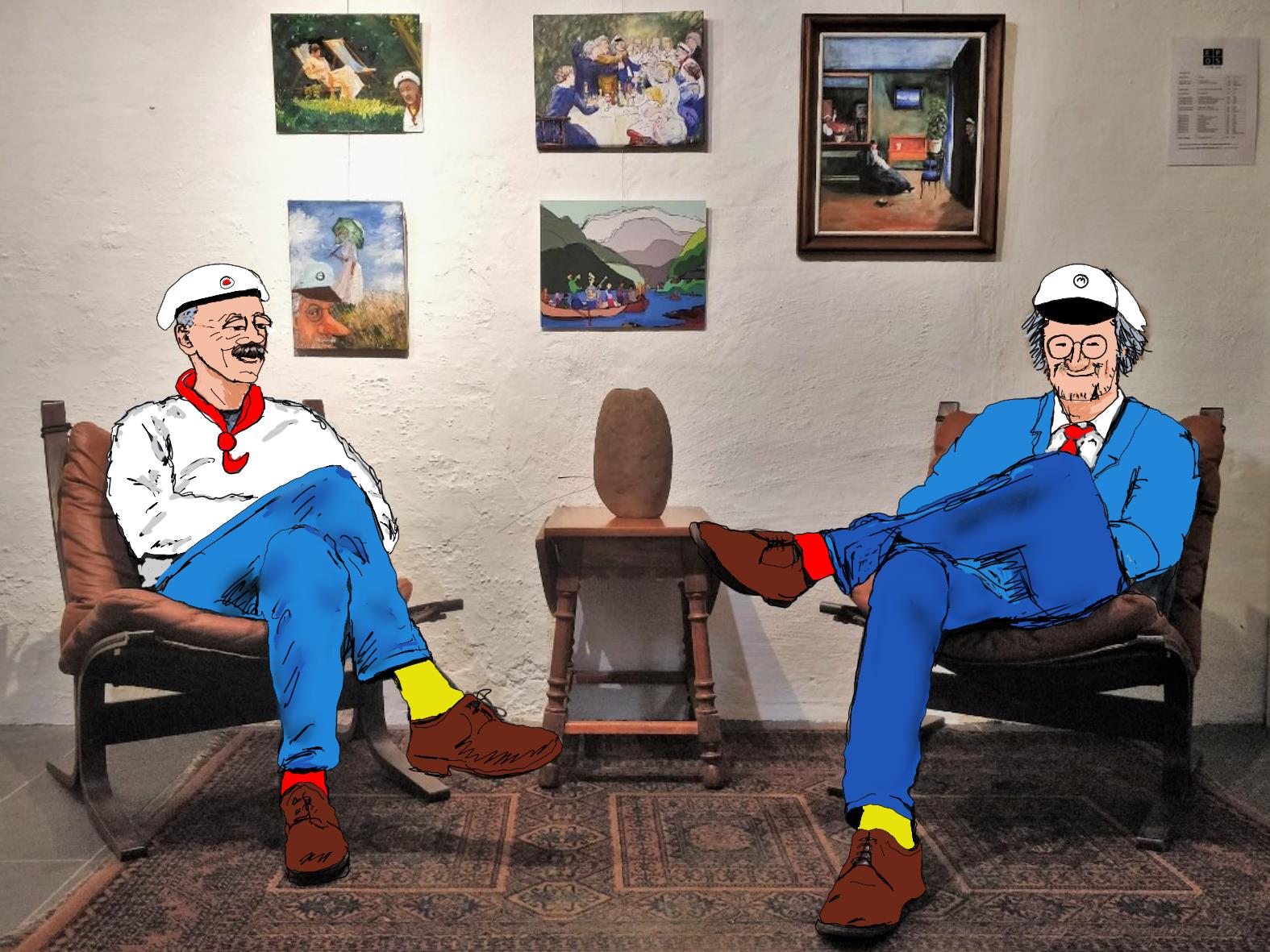 To menn sittende i en bilde garasje som fungerer som et galleri der det henger bilder på veggene.